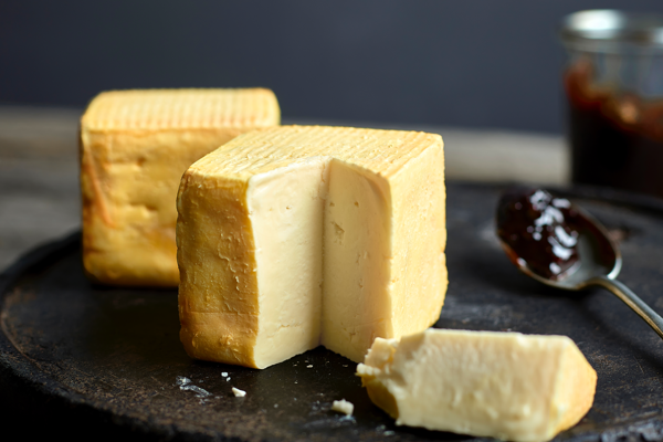 Block and a slice of cheese on a plate