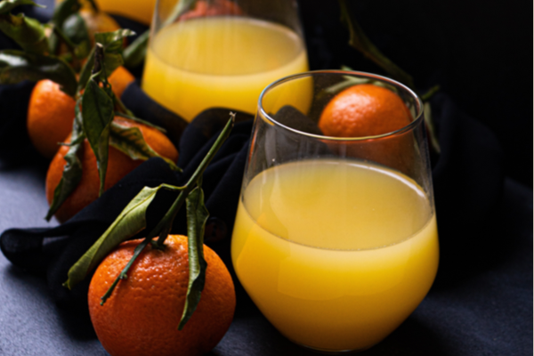 Oranges and a glass of orange juice